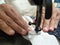 Close-up woman`s hands Dressmaker or seamstress working behind Vintage sewing machine with threaded needle ready to sew