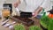 Close-up of a woman's hands, a farmer is pouring soil, earth into a tray for planting micro-green seeds