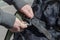 Close-up of a woman`s hands fastening an unbreakable carabiner t