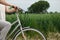 Close-up of a woman& x27;s hands on the handlebars of a bicycle with daisies.The focus is on daisies and woman hands. Copy Space.