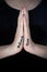 Close-up of woman`s hands held in prayer with hashtag  churchtoo written on hands