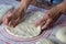 Close up of a woman`s hands making dough for homemade bread,female baker preparing bread on a silicone baking sheet