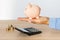 Close-up of a woman\'s hands with a piggy bank on the office table. crisis and inflation. Cost Management