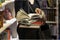 Close-up of woman`s hands with pile of books, bookstore. Education, school, study, reading fiction concept