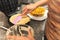 Close-up of a woman`s hands placing dough in a waffle iron