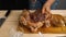 Close-up of a woman's hands salting and seasoning a chicken. A cut-up chicken lying on a cutting board. Cooking at