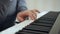 Close-up woman`s hands shows how to play the piano.