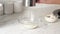 Close-up of a woman's hands sifting flour through a flour sifter.Slow motion