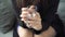 Close-up of a woman`s hands tapping her fingers on a glass of water. Stress and anxiety.