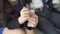 Close-up of a woman`s hands tapping her fingers on a glass of water. Stress and anxiety.