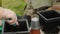 Close-up of a woman's hands with a trowel preparing the soil in a pot for replanting flowers. Transferring soil from