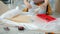 Close-up of woman's hands working with tools installing wooden furniture