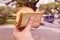 Close up woman`s left hand holding ice cream that wrapped sliced bread, street food in park, it is blurred background.