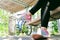 Close-up of woman\'s legs wearing gray-pink sneakers and black leggings. Bicycle, wooden canopy and concrete columns