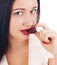 Close up of woman\'s lips biting a bar of chocolate