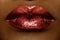 Close-up of woman\'s lips with bright fashion dark red glossy makeup. Macro lipgloss cherry make-up. kiss