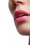 Close-up of woman\'s lips with bright fashion pink glossy makeup. Macro magenta lipgloss make-up. pink lip makeup