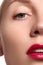Close-up of woman\'s lips with bright fashion red glossy makeup. Macro bloody lipgloss make-up. Red lips. Open mouth