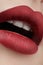 Close-up of woman\'s lips with fashion red make-up. Beautiful female mouth, full lips with perfect makeup. Classic visage