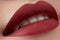 Close-up of woman\'s lips with fashion red make-up. Beautiful female mouth, full lips with perfect makeup. Classic visage