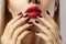 Close-up of woman`s lips with fashion red make-up and manicure. Beautiful female full lips with perfect makeup