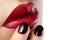 Close-up of woman\'s lips with fashion red make-up, nails. Beauty surgery, cosmetology