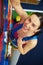 Close-up of woman in safety belt on the rock-climbing wall