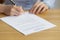 Close up woman signing contract, putting signature on official paper