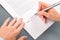 Close-up of woman signing document.