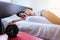 Close up of woman sleeping on bed in the bedroom with alarm clock blur background