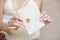 Close-up woman with slim body holding invitation envelope card in hands.