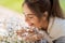 Close up of woman smelling chamomile flowers