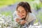 Close up of woman smelling chamomile flowers