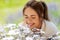 Close up of woman smelling chamomile flowers