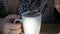 Close up of woman stirring an Irish coffee beverage in a mug on trendy diner in cafe