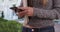 Close-up of woman students hands texting and holding books on college campus