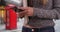 Close-up of woman students hands texting on phone and holding books in London