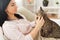 Close up of woman with tabby cat in bed at home