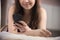 Close-up of woman taking myostimulation, smiling and holding her phone at the nutritionist`s office