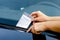 Close-up Of A Woman Taking Parking Ticket On Car`s Windshield