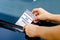 Close-up Of A Woman Taking Parking Ticket On Car`s Windshield