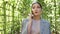 Close-up woman talking on the phone in a garden arch