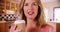 Close up of woman talking to camera and enjoying coffee inside kitchen