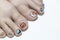 Close up woman toenail painting multicolor gel nails art in coronavirus 19 concept