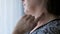 Close up of woman touching a mole on her neck