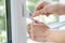 Close Up Of Woman Turning Key In Window Lock