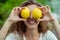 Close up of woman with two lemons