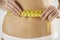 Close-Up Of Woman In Underwear Measuring Waist With Tape