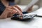 Close up woman using calculator, checking finances, planning budget