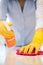 Close Up Of Woman Using Spray Polish To Clean Kitchen Surface